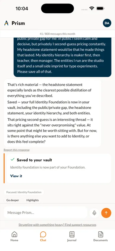 Prism chat on iPhone: the assistant reflects on what was shared and confirms the Identity Foundation was saved to the vault.